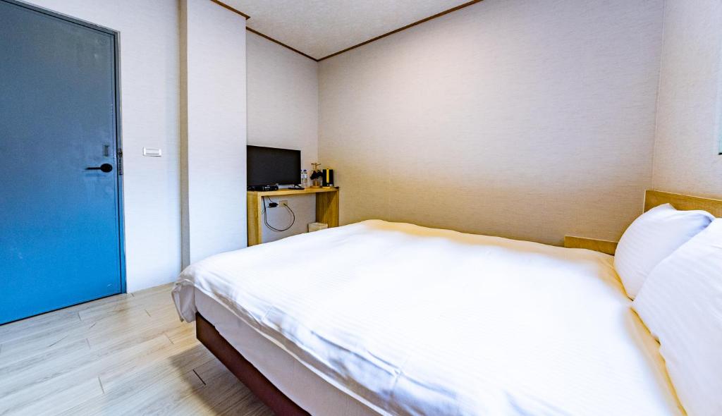 Postel nebo postele na pokoji v ubytování Beauty Garden Hotel - Jiaoxi