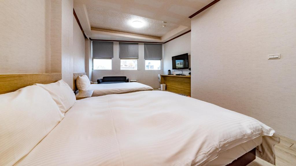 Postel nebo postele na pokoji v ubytování Beauty Garden Hotel - Jiaoxi