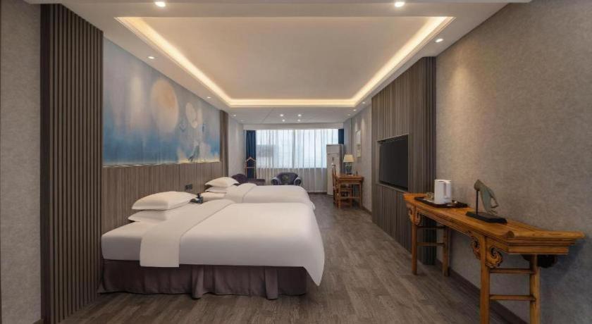 Postel nebo postele na pokoji v ubytování Xi'an Huiya Tianmu Hotel