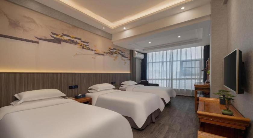 Postel nebo postele na pokoji v ubytování Xi'an Huiya Tianmu Hotel