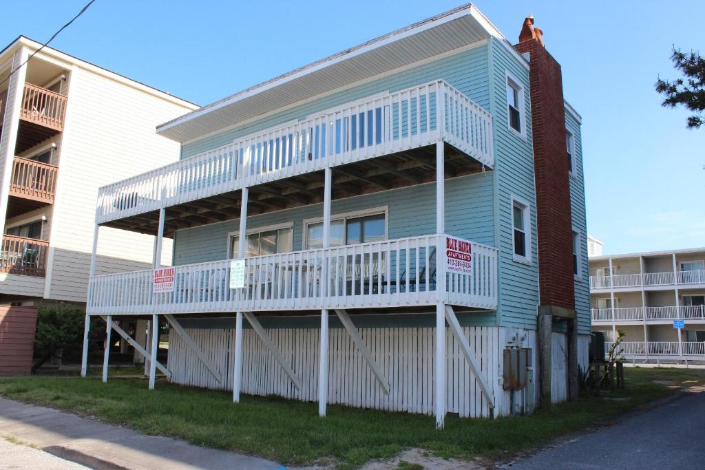 a blue building with a balcony on the side of it at Blue Haven Apartments in Ocean City