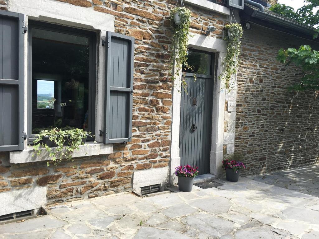 a brick building with a door and two windows at Atelier n°5 in Wanze