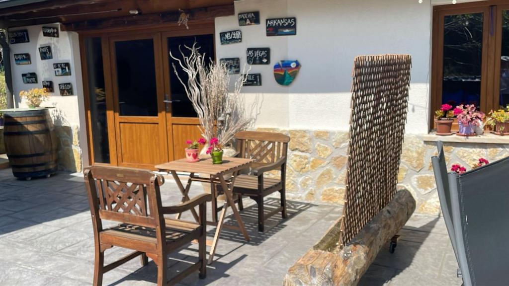 a wooden table and chairs on a patio at Gure Txokoa in Cerain