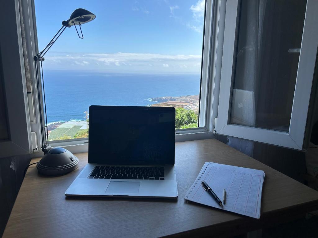 a laptop computer sitting on a desk in front of a window at Casa La Oliva in Garachico