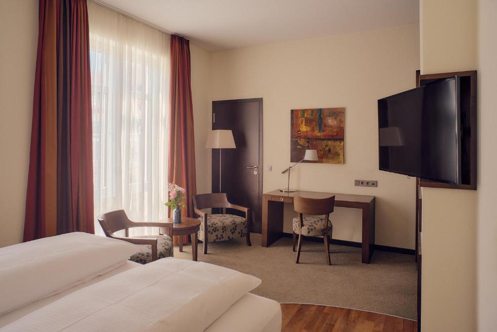 Postel nebo postele na pokoji v ubytování Aparthotel am Golfclub Treudelberg