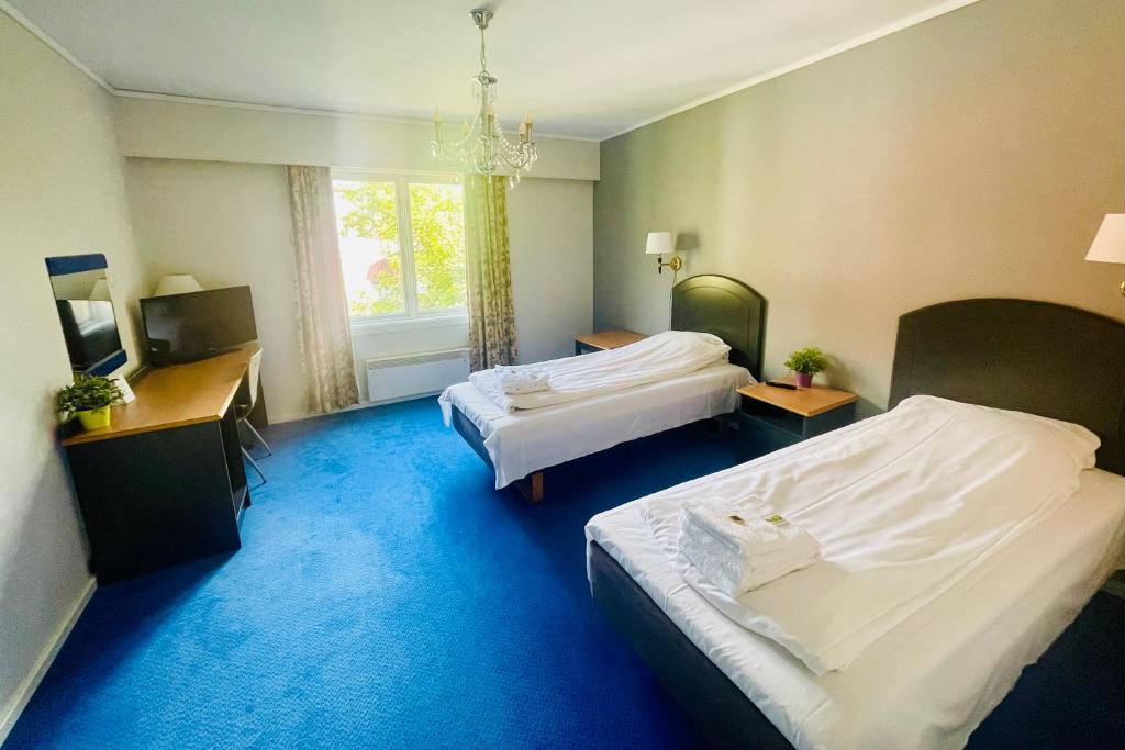 Postel nebo postele na pokoji v ubytování Suldal Hotell