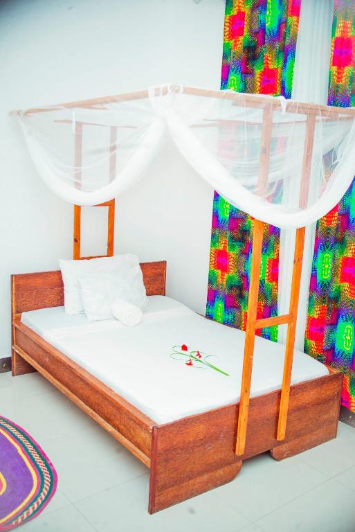 Postel nebo postele na pokoji v ubytování Kilimanjaro