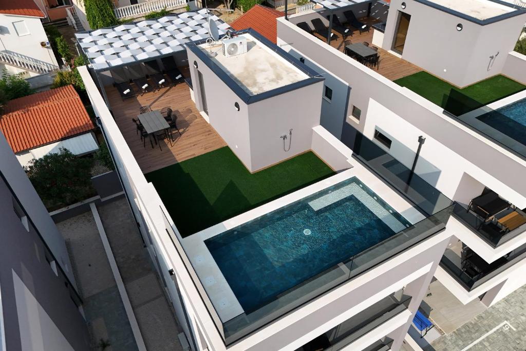 an aerial view of a house with a swimming pool at K2-Penthouse with sea view and heated pool in Vir