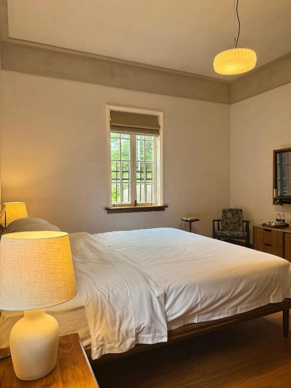Postel nebo postele na pokoji v ubytování Xiamen Gulangyu Bishan Residence