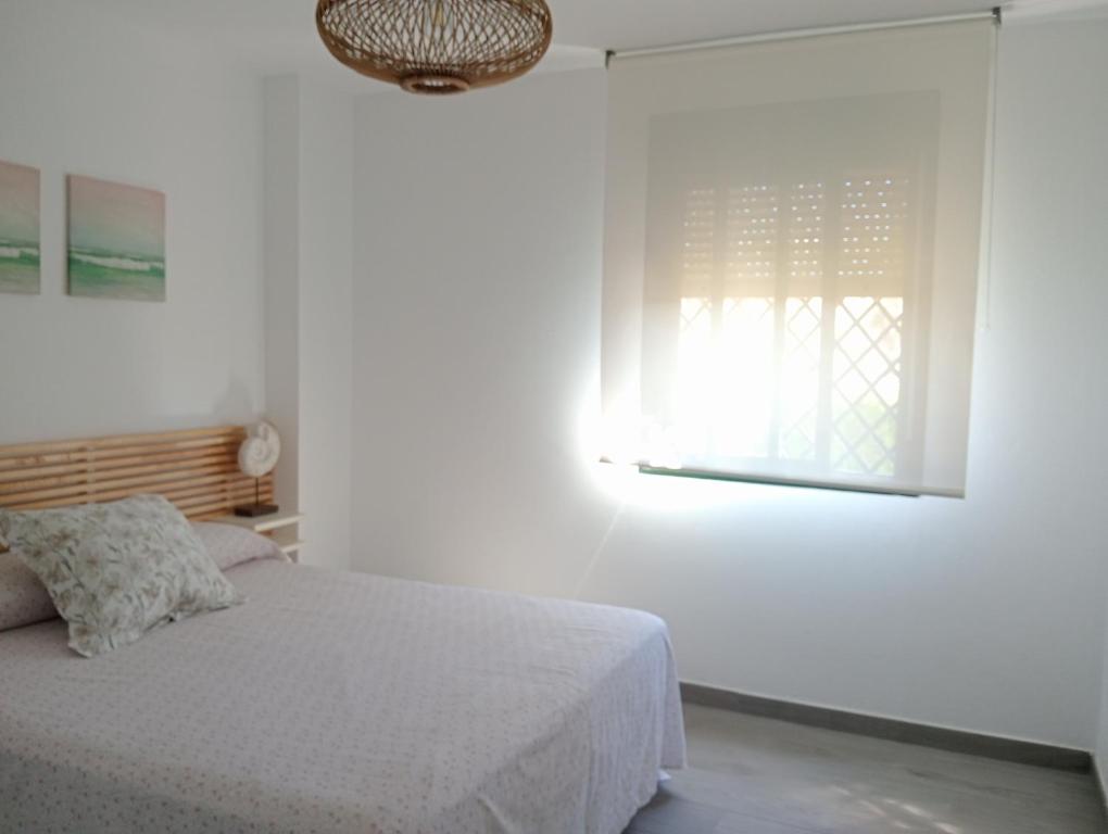 Postel nebo postele na pokoji v ubytování Apartamentos Vacacionales Atlanterra