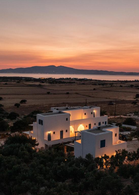 a view of a building with the sunset in the background at Aurea Blu Studio 08, Enjoy, Relax, Dream in Aliko Beach