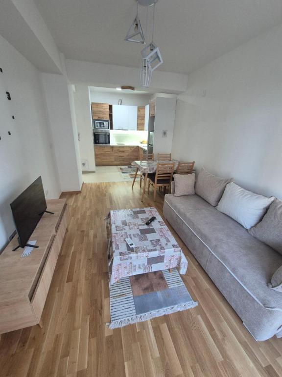 a living room with a couch and a table at Golden 25 Skopje in Skopje