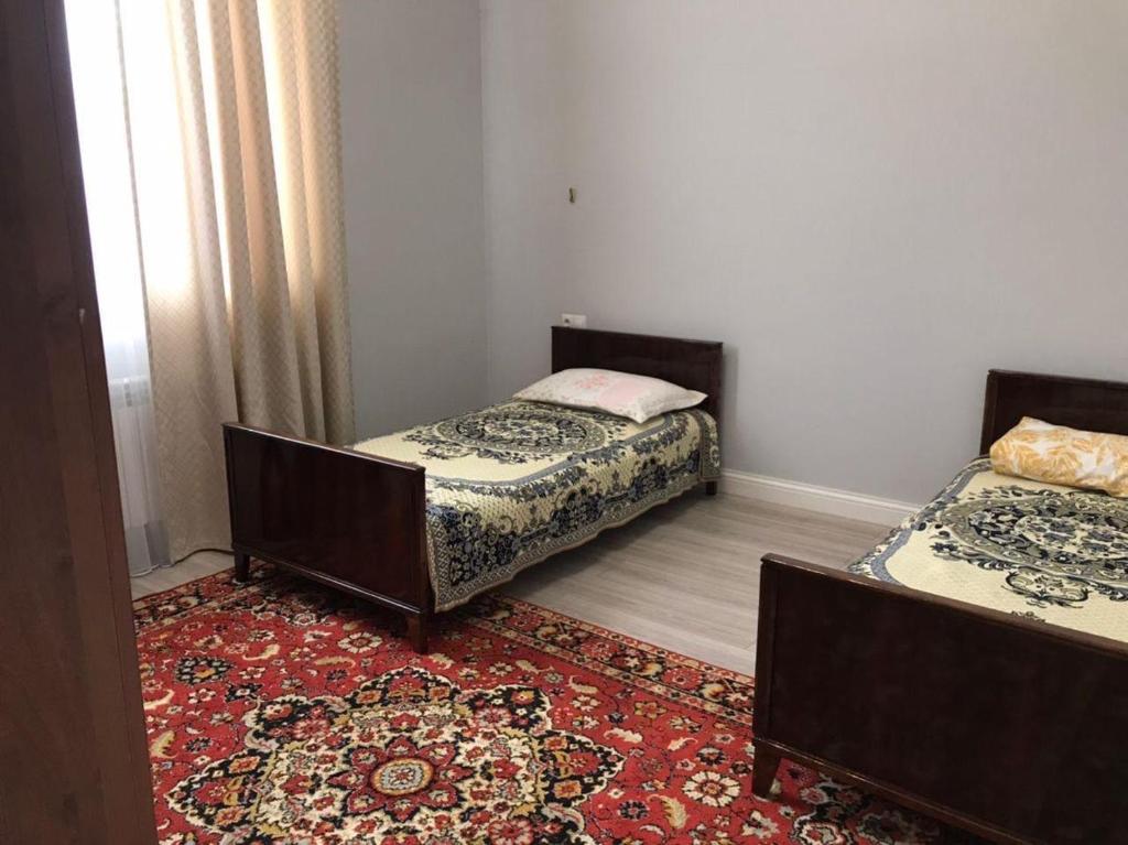 Postel nebo postele na pokoji v ubytování Tuzdybastau Guest House
