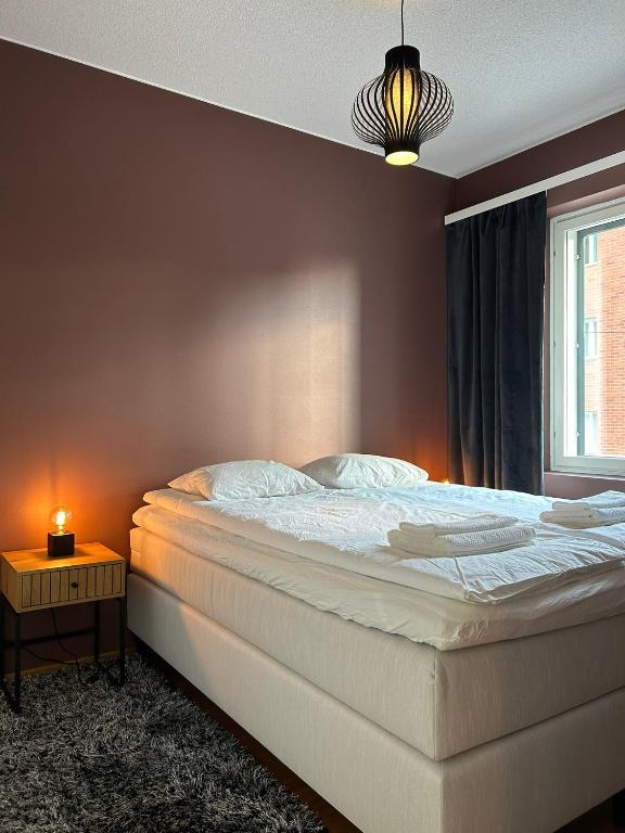 a bedroom with a large bed and a window at One bedroom apartment in Rovaniemi