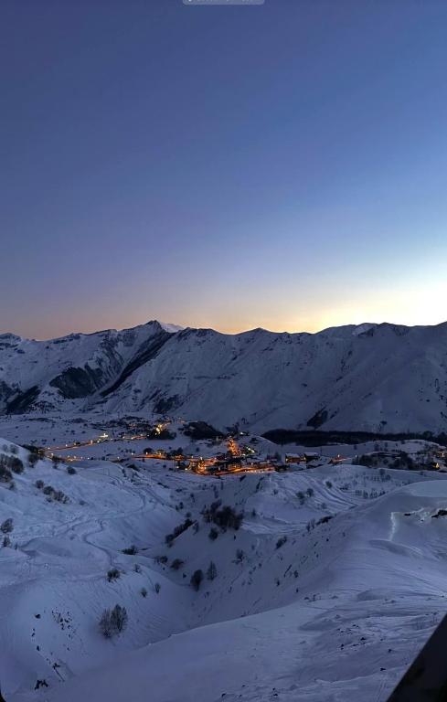 a town in the middle of a snow covered mountain at New Gudauri Twins in Gudauri