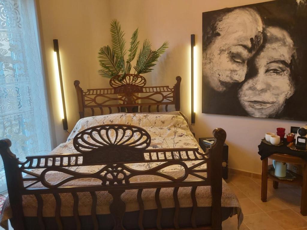 a bed in a room with a painting on the wall at La Bandiera Blu in La Spezia