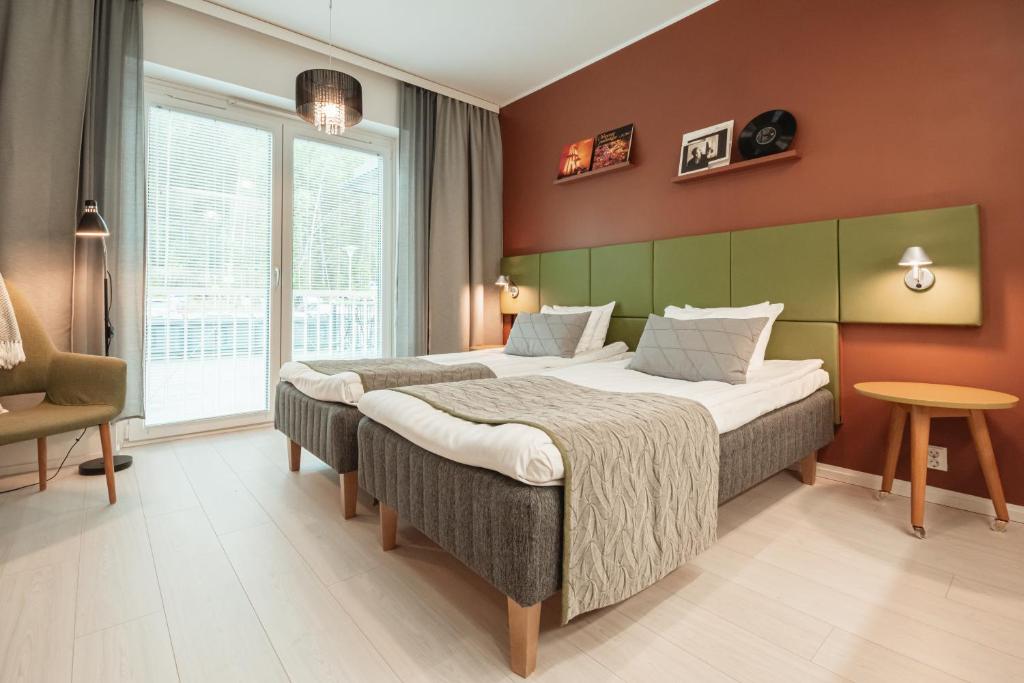 Ένα ή περισσότερα κρεβάτια σε δωμάτιο στο Time Apartments Ylistönmäki