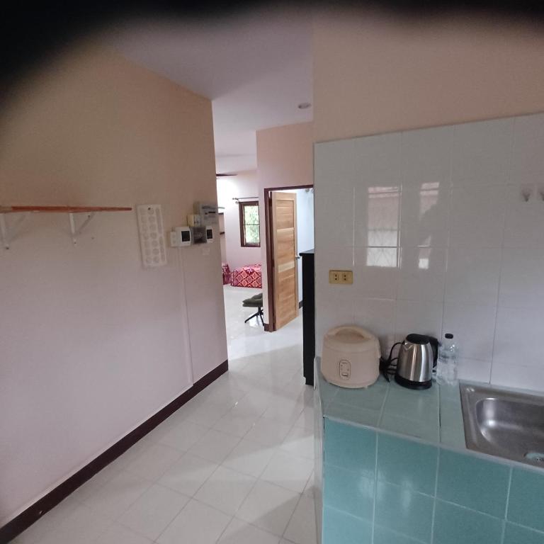 a kitchen with a sink and a counter top at Lamai viking bungalow in Koh Samui