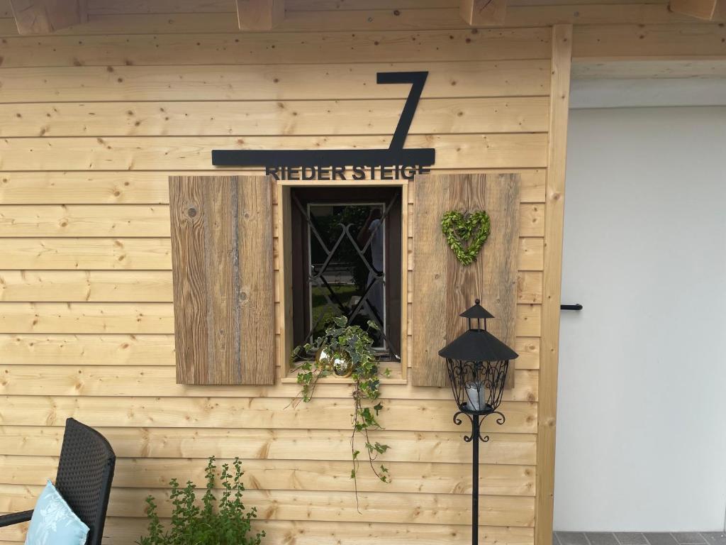 a building with a window and a sign on it at Ferienwohnungen Mews in Immenstadt im Allgäu