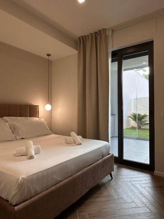 a bedroom with a bed and a sliding glass door at Venus Suites in Bari