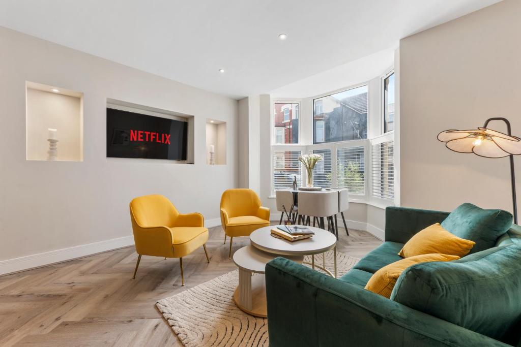 a living room with a couch and chairs and a table at Pleasure Beach Apartments by Central Beach Leisure in Blackpool