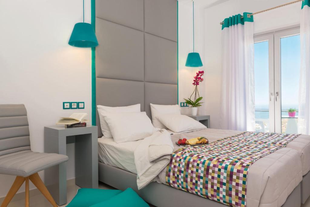 a bedroom with a bed with a desk and a chair at Sweet Pop in Fira