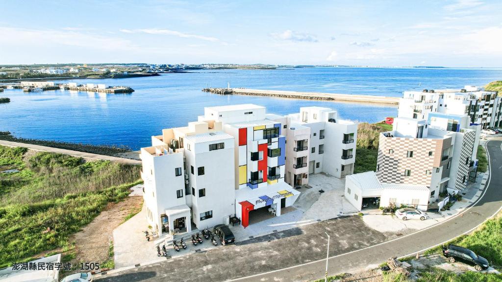 an aerial view of white buildings by the water at Mondrian Seaview Guest House in Magong