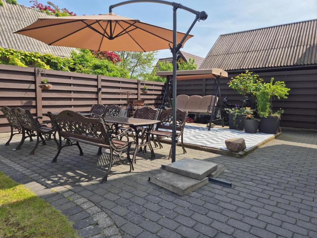 a patio with a table and chairs and an umbrella at Palanga S3 in Palanga