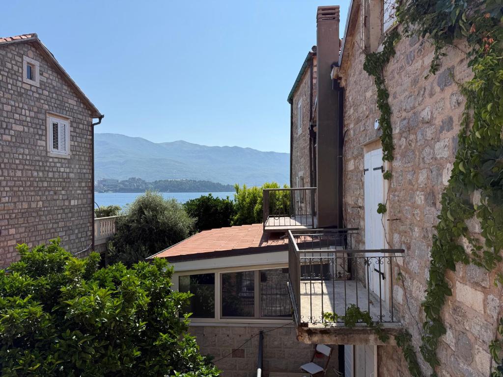 an external view of a house with a balcony at Private double room in the Old Town in Budva