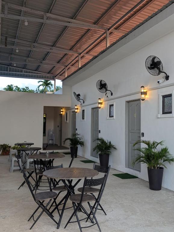a group of tables and chairs in a room with lights at Din's Studio Homestay in Semporna