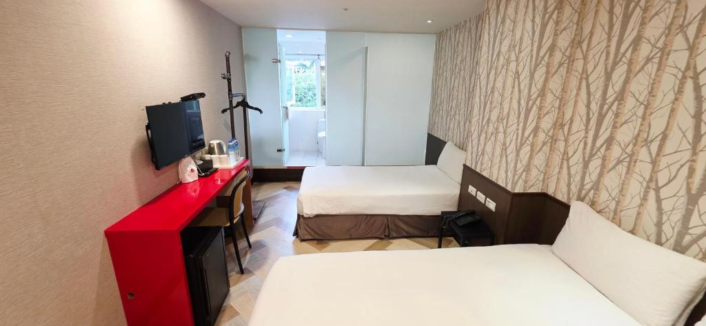 Postel nebo postele na pokoji v ubytování 喜園旅館Ximen Garden Inn