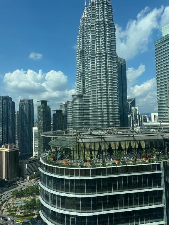 a view of a large city with tall buildings at Sleep in the Sky KLCC View in Kuala Lumpur