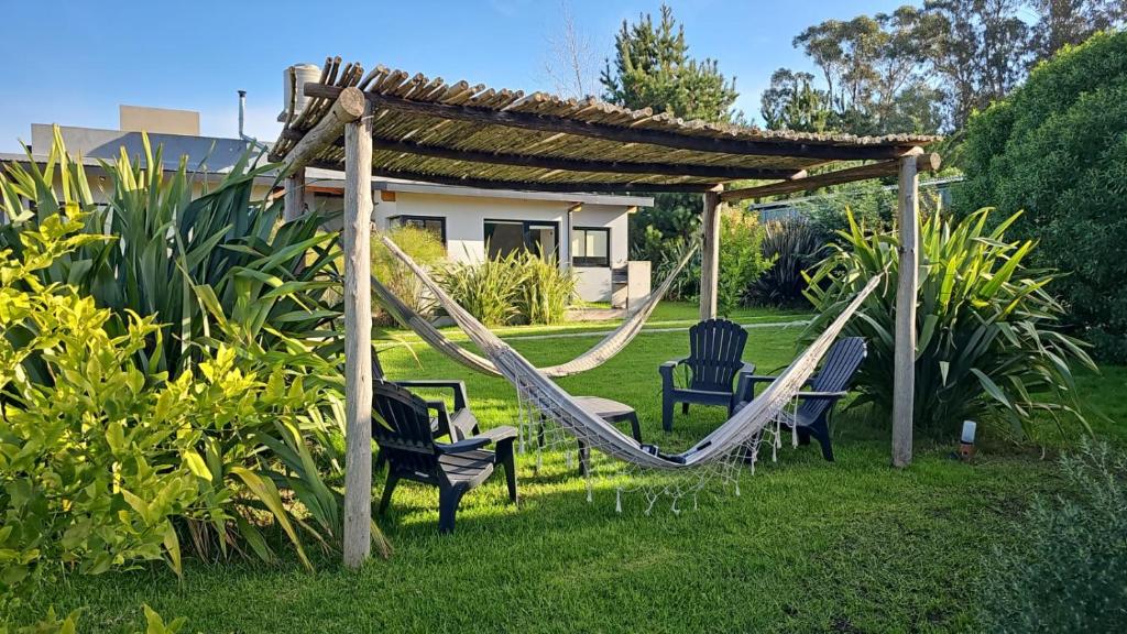 a swing set in a yard with a gazebo at LP Loft Acantilados in Mar del Plata