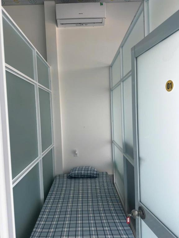 a room with a corridor with a door and a bed at Bằng Lăng Tím in Ấp Bình Tú