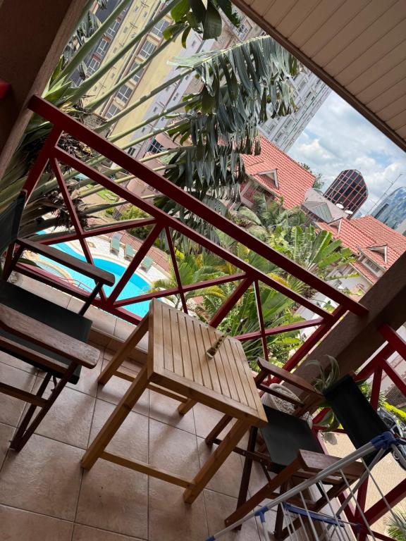 a view of a balcony with a bench and a pool at La Pace One Bedroom Home, Rhapta Road Westlands Nairobi in Nairobi