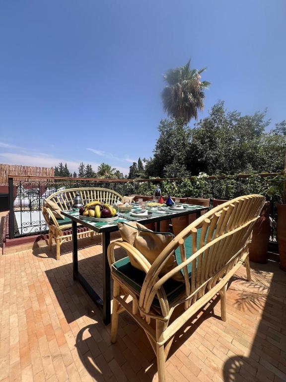 a table with fruit on it on a patio at Riad 2 Ksour Marrakesh in Marrakesh