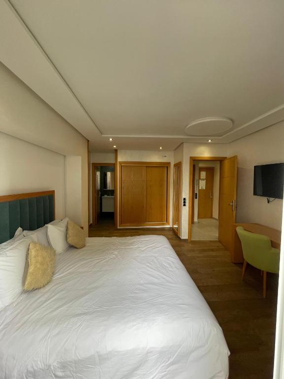 Postel nebo postele na pokoji v ubytování Hotel Residence Ramsis