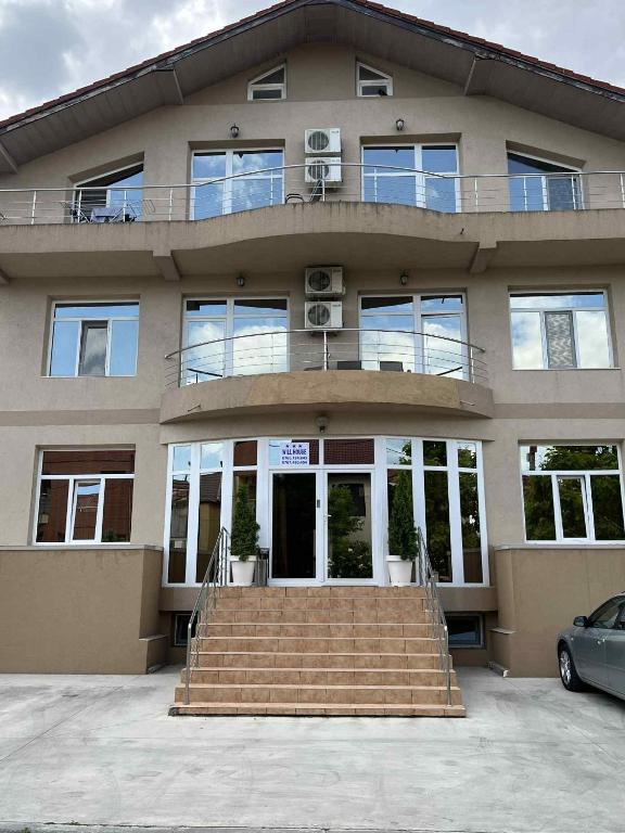 a building with a staircase in front of it at Virginia Mamaia-Nord in Mamaia Sat/Năvodari