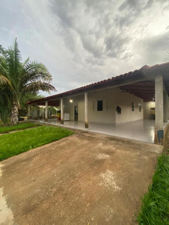 a large white building with a parking lot at Rancho Pé de Serra in Manhã