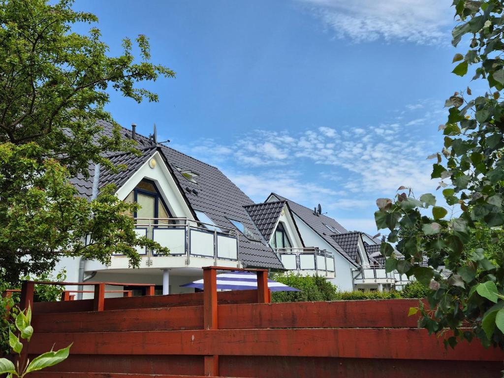a white house with a black roof at Ferienwohnung Schultz in Zinnowitz