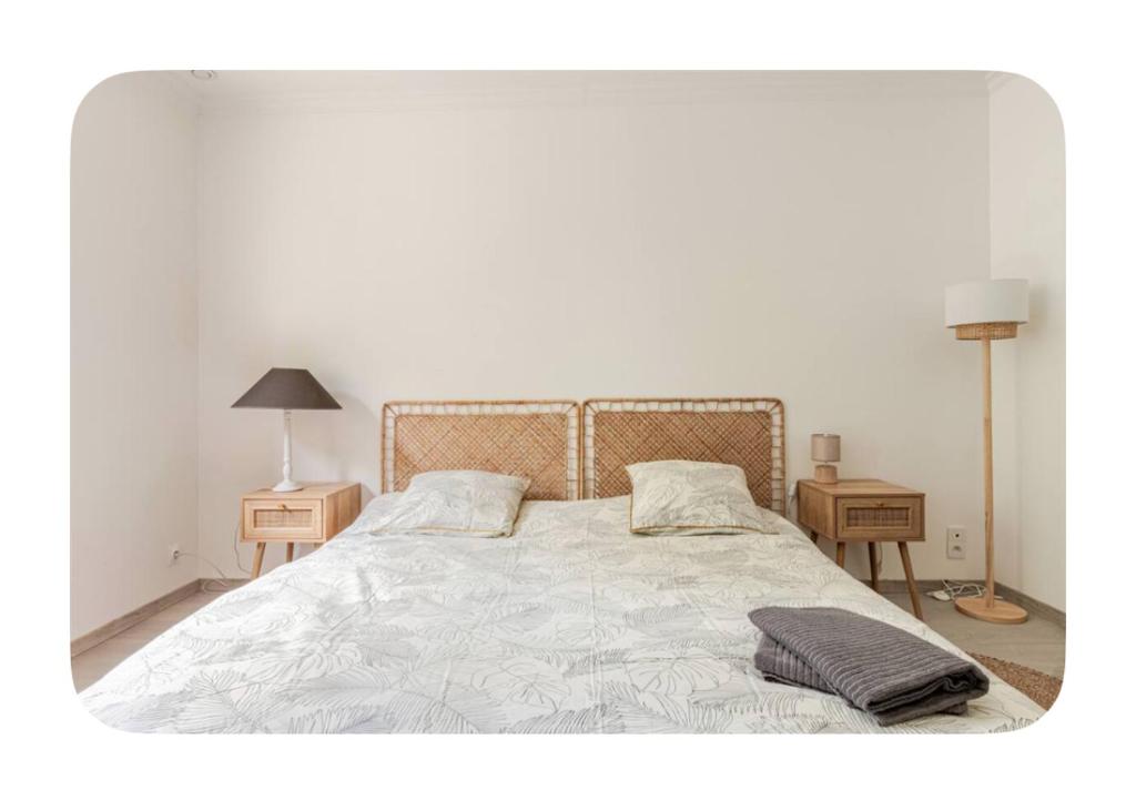 a bedroom with a large bed with two night stands at Hôtel Thiron Gardais in Thiron-Gardais