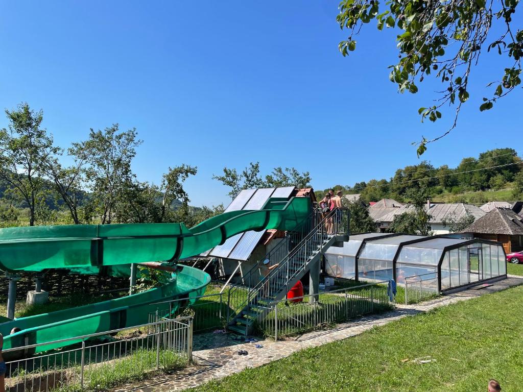 a slide at a playground in a park at Cabana Iza in Bîrsana