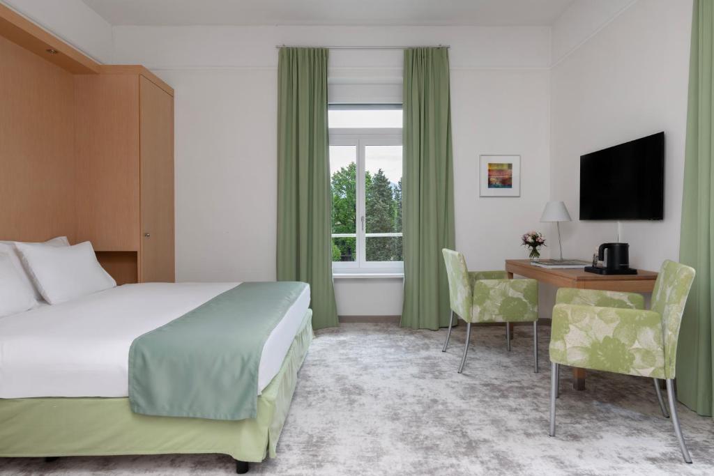 Postel nebo postele na pokoji v ubytování Grand Hotel Europe