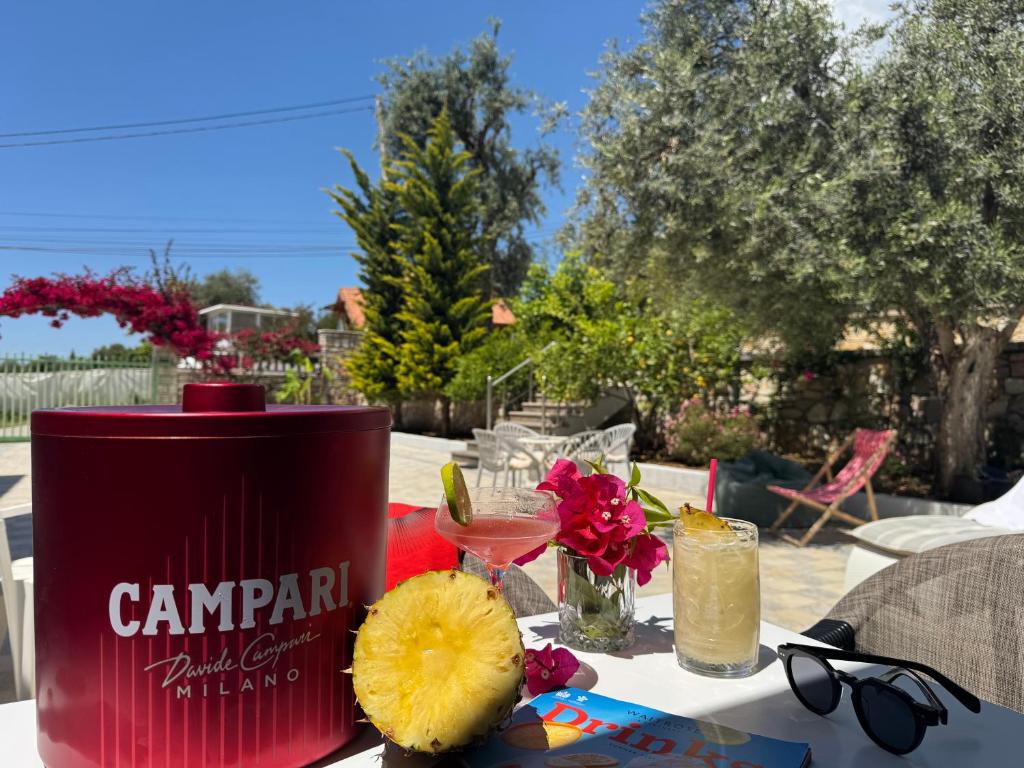 a red can sitting on a table with a drink at Augustus Hotel in Dhërmi