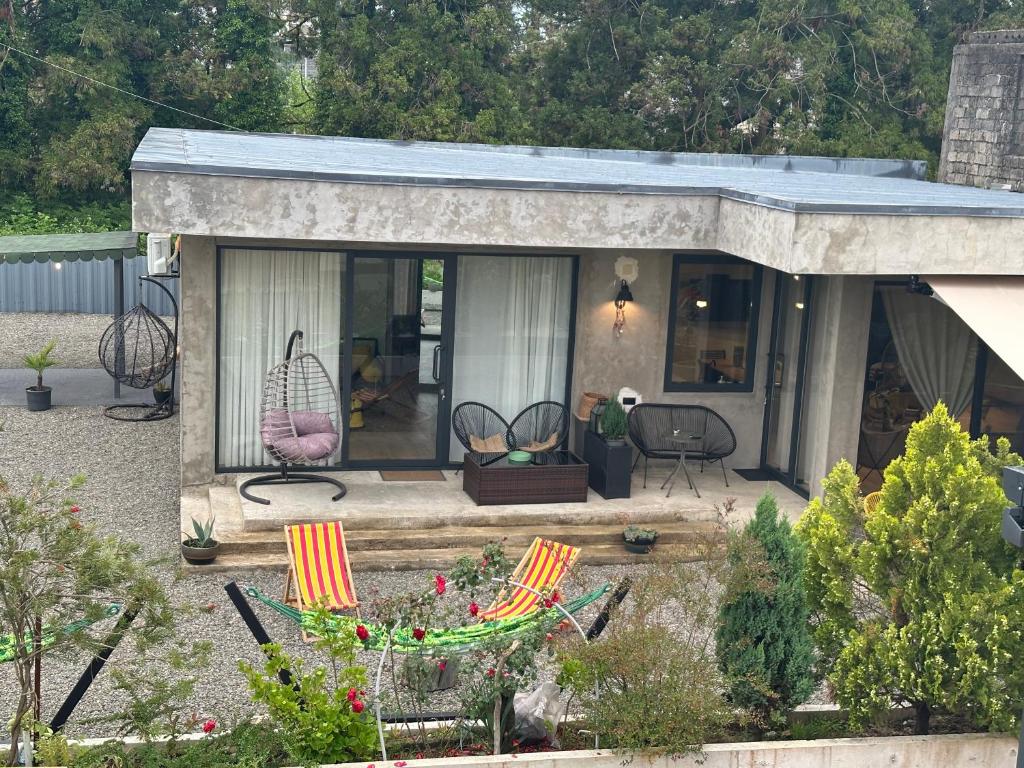 a small house with chairs and a patio at The Best House in Ureki