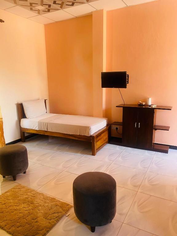 Postel nebo postele na pokoji v ubytování Woodnest Saayoo Resort