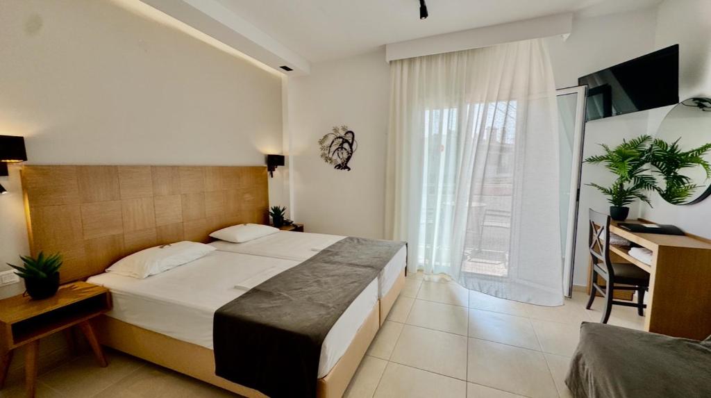 A bed or beds in a room at Sarantis Hotel