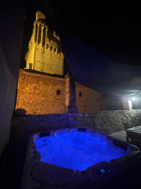 une grande baignoire bleue devant un immeuble dans l'établissement Maison traditionnelle Gardoise avec Jacuzzi 5 personnes 3 chambres, à Saint-Laurent-des-Arbres