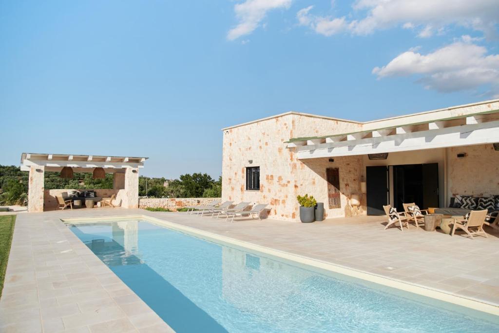 une villa avec piscine devant une maison dans l'établissement Villa Batu stylish 2 bedroom, à Cisternino