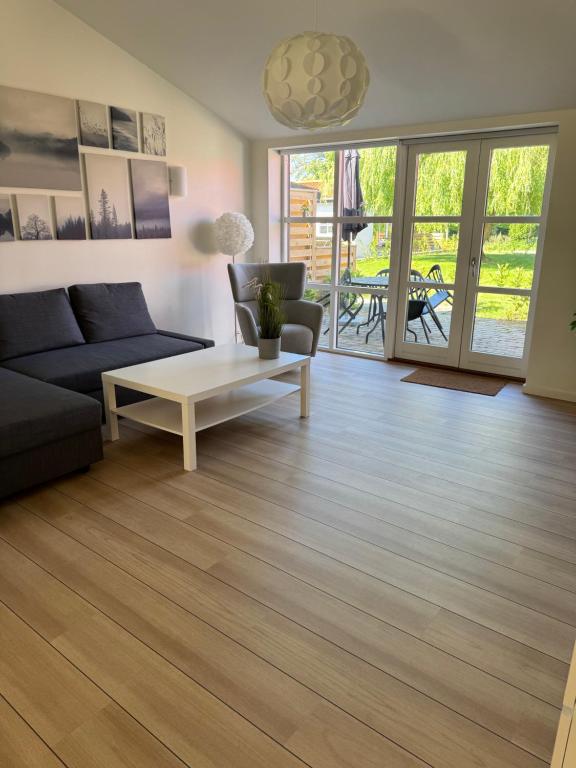 a living room with a couch and a coffee table at Bøtø strand ferielejlighed 3 in Bøtø By